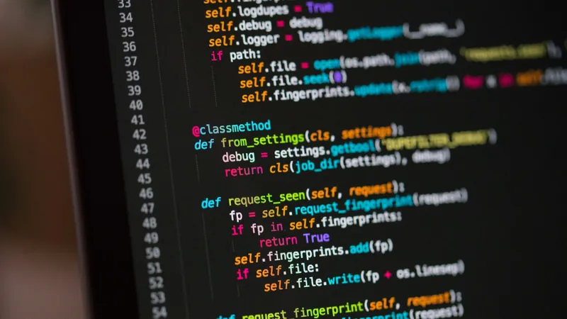 Lines of code on a computer screen in a dark room