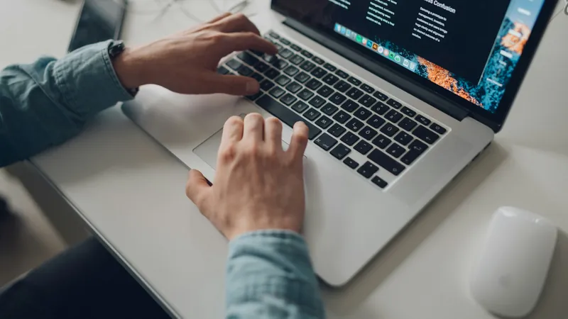 Person typing on a laptop at a desk